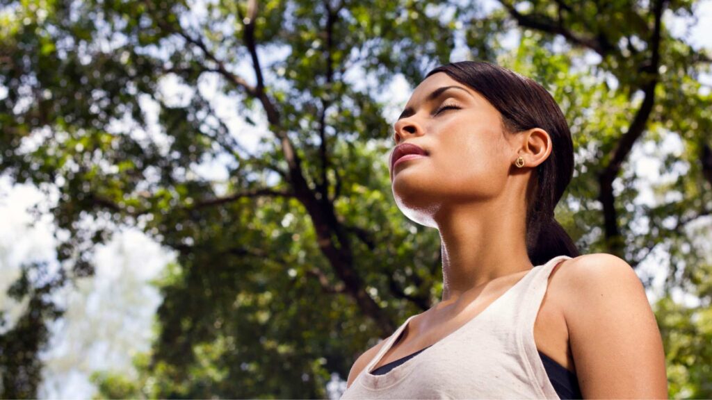 Person breathing in the forest having a taste of fresh air