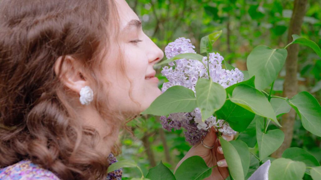 Science of Scent (1) Woman smelling a flower and having a great time